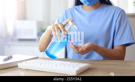 Hand applying Alcohol gel sanitazer liquid cleaning hands for prevent corona virus covid-19. woman hand sanitizer Alcohol gel gel for hand hygiene Stock Photo