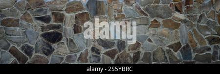 Rustic old beige brick worn foundation with shabby brown stones close up texture. Rustic old beige brick worn foundation with shabby brown stones Stock Photo