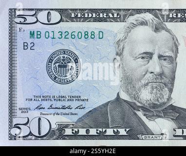 A US $50 bill (with Ulysses S. Grant) layered over a $100 bill