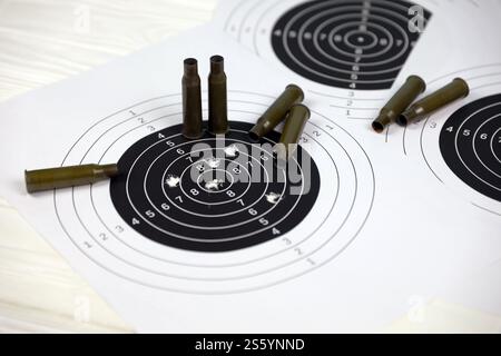 Led Bullets Target Many bullets with shooting targets on white table in shooting range ...