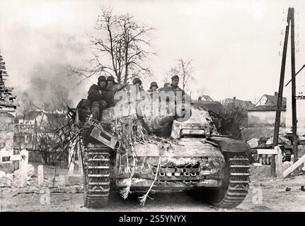 Grenadiers of the 4th SS Panzer Corps ridfing on Stug IV in a Hungarian village,  ​​Lake Balaton. The third phase of the German operation  Conrad . Hungary, J - Historical document, photographer unknow Stock Photo