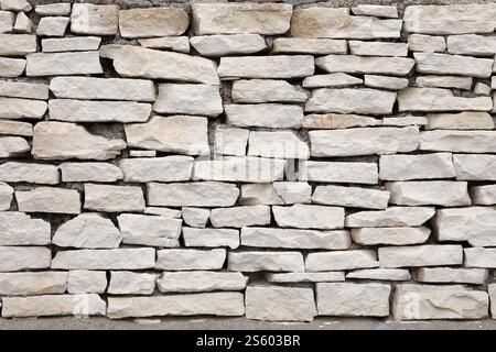 Texture of a stone wall background. Part of a stone fortress or castle fencing for background. Texture of a stone wall background from small stones Stock Photo