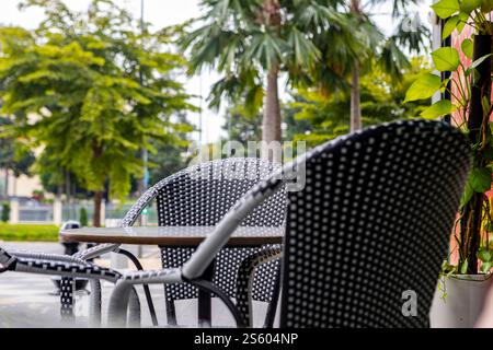 A table and chairs at an openair restaurant in Ho Chi Minh City, Vietnam Stock Photo