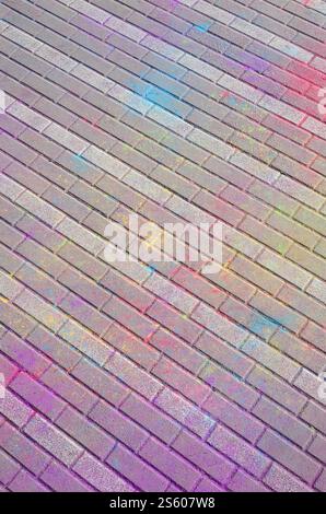 Multi colored earth, paving slabs, powder coated with dry colors at the Holi festival close up. Multi colored paving slabs, powder coated with dry Stock Photo