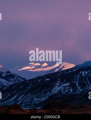 Snow-covered peaks in Nesjavellir, South Iceland, bathed in purple twilight Stock Photo