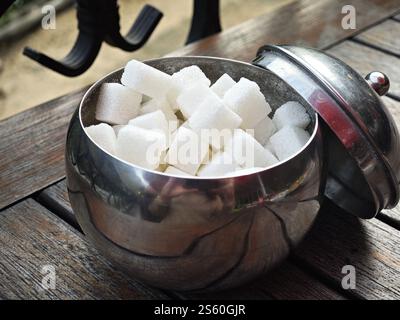 Sugar cubes in a stainless steel sugar bowl Stock Photo