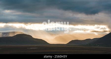 Sun rays breaking through clouds over Hoffellsjökull glacier in South Iceland. Stock Photo
