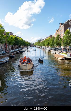 Editorial image of a lively canal scene in Amsterdam with a group of ...