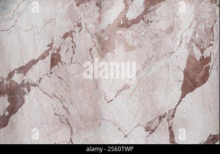A detailed closeup of marble texture showing natural beige and brown veins and cracks Stock Photo