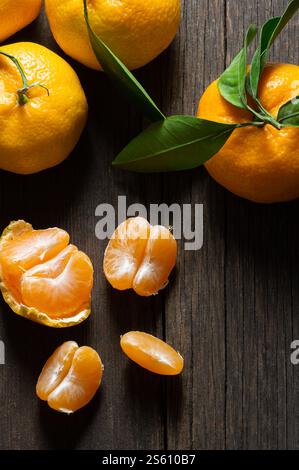 Fresh ripe juicy yellow mandarin ( clementine, tangerine ) on rustic vintage table with leaf. Winter fruit background concept Stock Photo