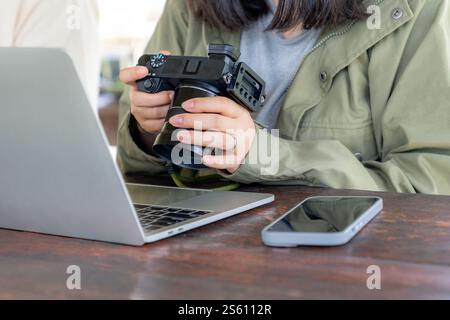 female checking a picture on digital camera Stock Photo
