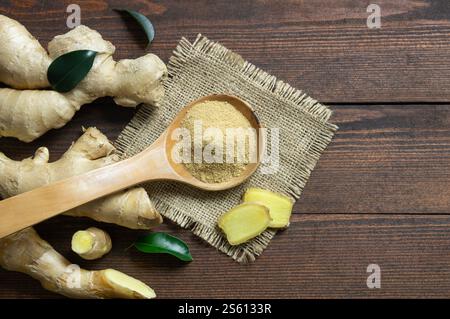 Fresh chopped ginger root and ground ginger powder in wooden spoon on wooden rustic table. Healthy food, spice. Zingiber officinale Stock Photo