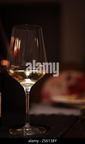Sunset Vineyard Elegance: Wine Glasses Amidst Lush Grapevines Stock Photo