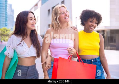 Three Happy Women Shopping and Strolling Outdoors. Stock Photo