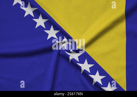 Bosnia and Herzegovina flag is depicted on a sports cloth fabric with many folds. Sport team waving banner. Bosnia and Herzegovina flag is depicted Stock Photo