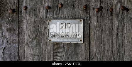 No Smoking sign on old wooden background with rusty nails Stock Photo