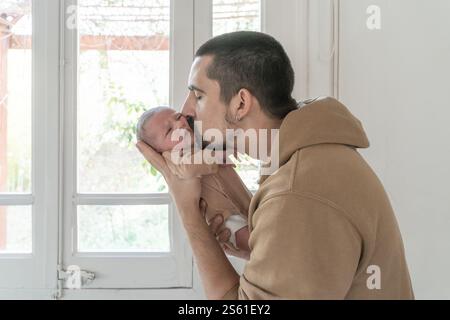 Father kissing his newborn daughter. Stock Photo