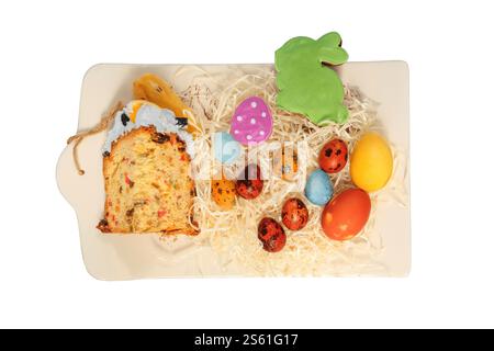 Easter cake, cookies and painted eggs in ceramic tray. Isolate on a white background. Easter traditions. Variety of homemade foods. Country style. Stock Photo