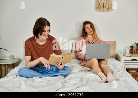 Young adults relax together in a cozy bedroom, engaging in their own activities. Stock Photo