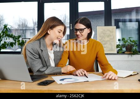 Two young people engage in a lively discussion about their project while working together. Stock Photo