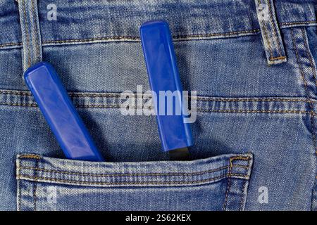 Blue pliers and locking pliers in rear pocket of blue jeans. Top view Stock Photo