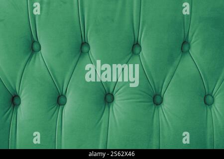 Capitone, diamond checkered soft fabric textile decorative background with buttons. Classic retro Chesterfield style, luxurious upholstery green textu Stock Photo