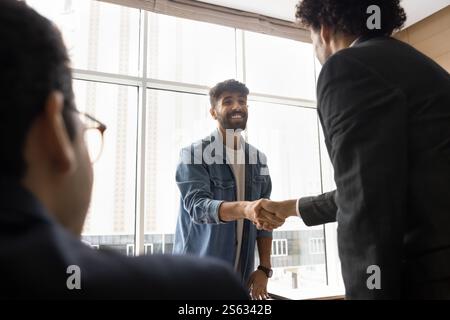 Two positive successful Arabian businessmen shaking hands Stock Photo