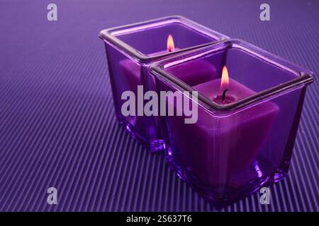 Purple Candle Glow. Two purple candles in glass holders Stock Photo