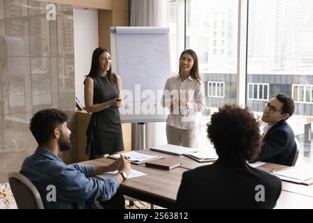 Two young multiethnic trainers hold corporate training event for staff Stock Photo
