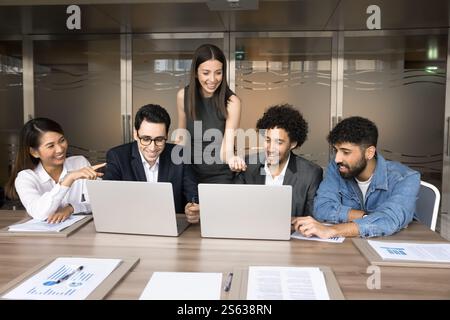 Creative business team gathered in office working together on project Stock Photo