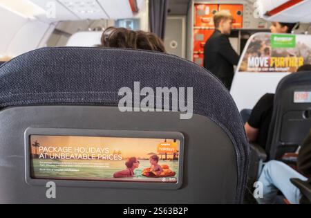 Easyjet flight from Edinburgh to Lisbon, holidays advertised on back of passenger seats. Stock Photo