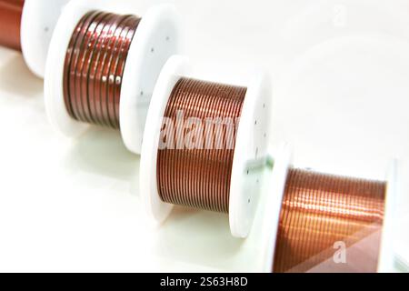 Winding enamelled copper wire on coils Stock Photo
