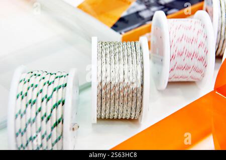 Metal and fabric braided cables on spools in store Stock Photo
