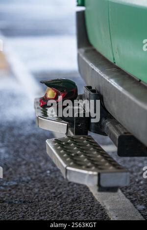 Tiny BMX helmet on the tow bar of a van Stock Photo