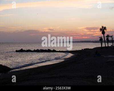 Silhouettes of Plamen in the sunset of Marbella Spain Stock Photo