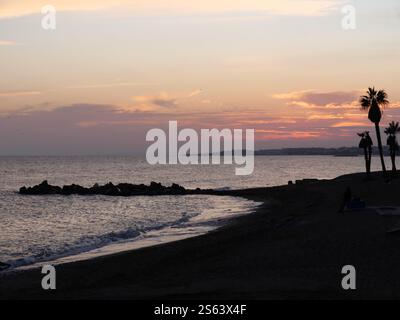 Silhouettes of Plamen in the sunset of Marbella Spain Stock Photo