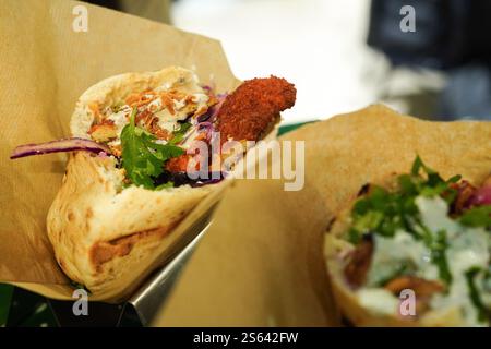 Pita sandwich with crispy chicken, cabbage and tomato Stock Photo