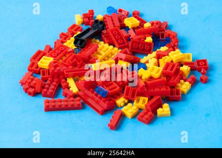 Plastic building blocks isolated on blue background. Plastic construction kit Stock Photo