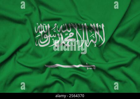 Saudi Arabia flag is depicted on a sports cloth fabric with many folds. Sport team waving banner. Saudi Arabia flag is depicted on a sports cloth Stock Photo