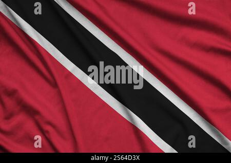Trinidad and Tobago flag is depicted on a sports cloth fabric with many folds. Sport team waving banner. Trinidad and Tobago flag is depicted on a Stock Photo