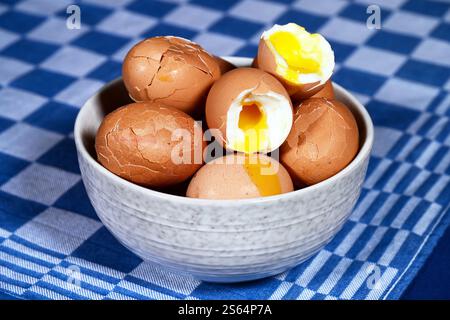 Broken soft-boiled chicken eggs in a bowl Stock Photo