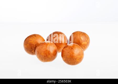 Macadamia integrifolia - Organic macadamia nuts on white background. Stock Photo