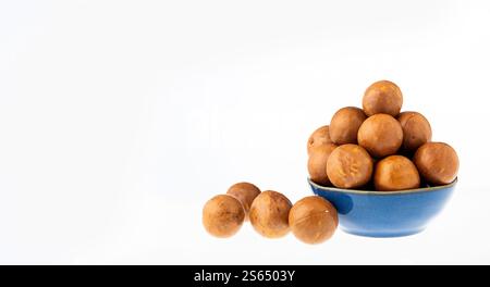 Organic macadamia nuts in bowl - Macadamia integrifolia. Stock Photo