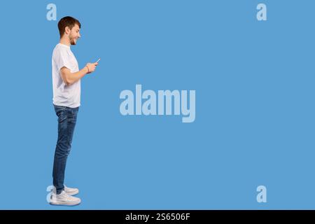 Portrait of handsome young man using mobile phone Stock Photo