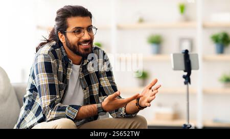 handsome arab guy with glasses blogger streaming from home Stock Photo