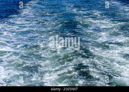 The whitewash pattern is created by the backwash of a small ship. Stock Photo