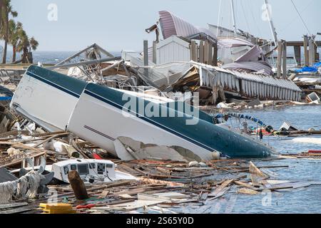 Massive devastation at a marina as boats lie overturned and shattered, the aftermath of Hurricane Michael's unrelenting force. Stock Photo