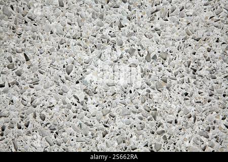 Broken recycled glass set in a concrete cement terrazzo flooring tile design. Stock Photo