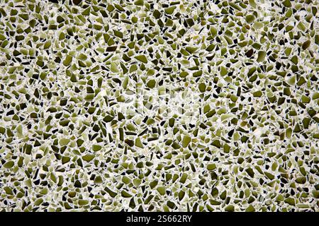 Broken recycled glass set in a concrete cement terrazzo flooring tile design. Stock Photo
