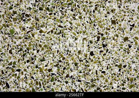 Broken recycled glass set in a concrete cement terrazzo flooring tile design. Stock Photo